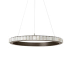 Wide dark bronze alabaster chandelier viewed near eye level, its open centre and stone tiles unlit.