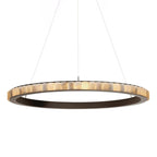 Large dark bronze alabaster chandelier lit, the stone tiles glowing warm around the full ring.