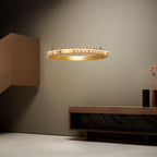 Brass alabaster chandelier lit beside a wall above a wooden console with a dark marble insert.
