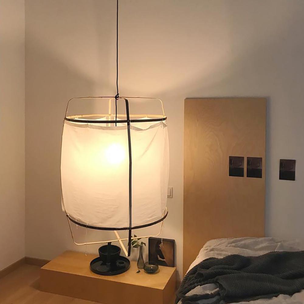 Bamboo pendant light with woven shade glowing softly