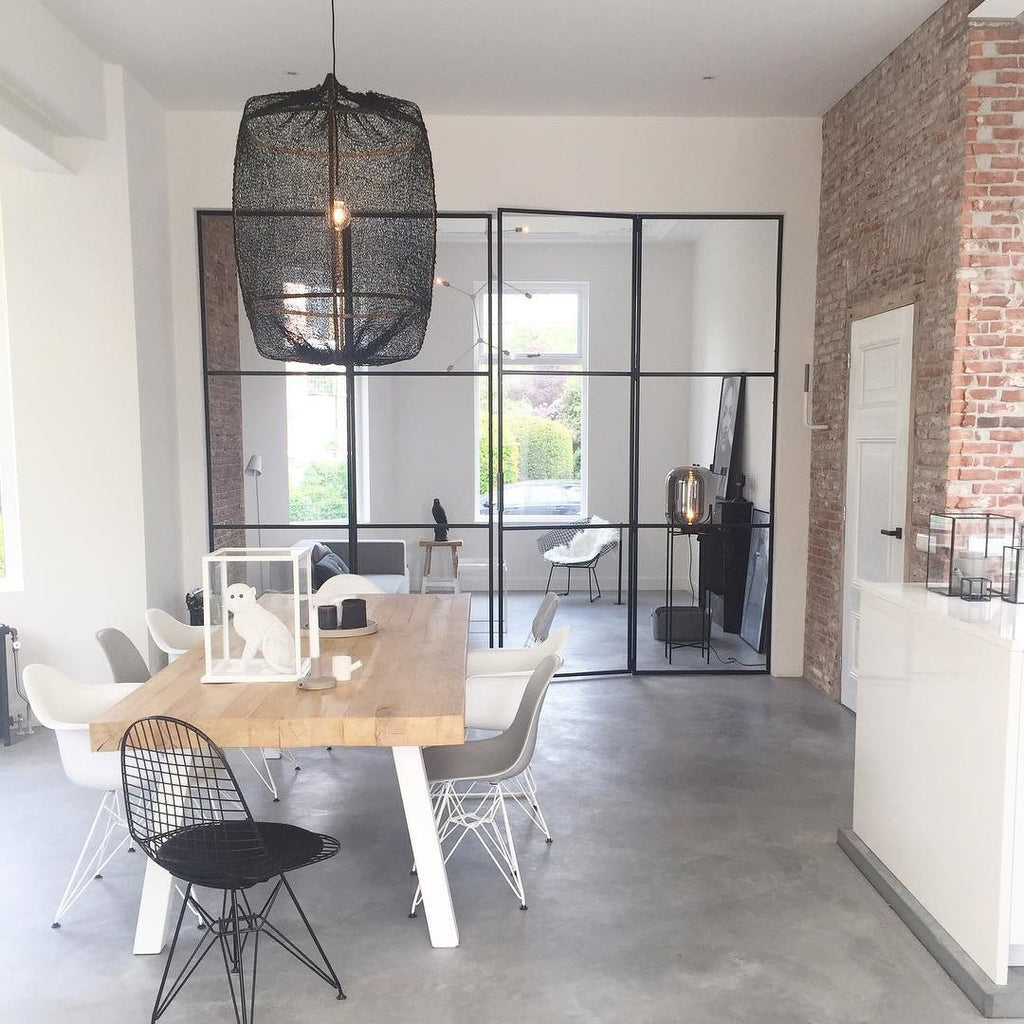 Bamboo pendant light glowing above a relaxed living space