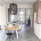 Bamboo pendant light glowing above a relaxed living space