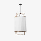 Bamboo pendant light with linen shade over a dining table