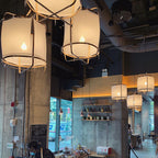 Bamboo pendant light hanging above a seating area