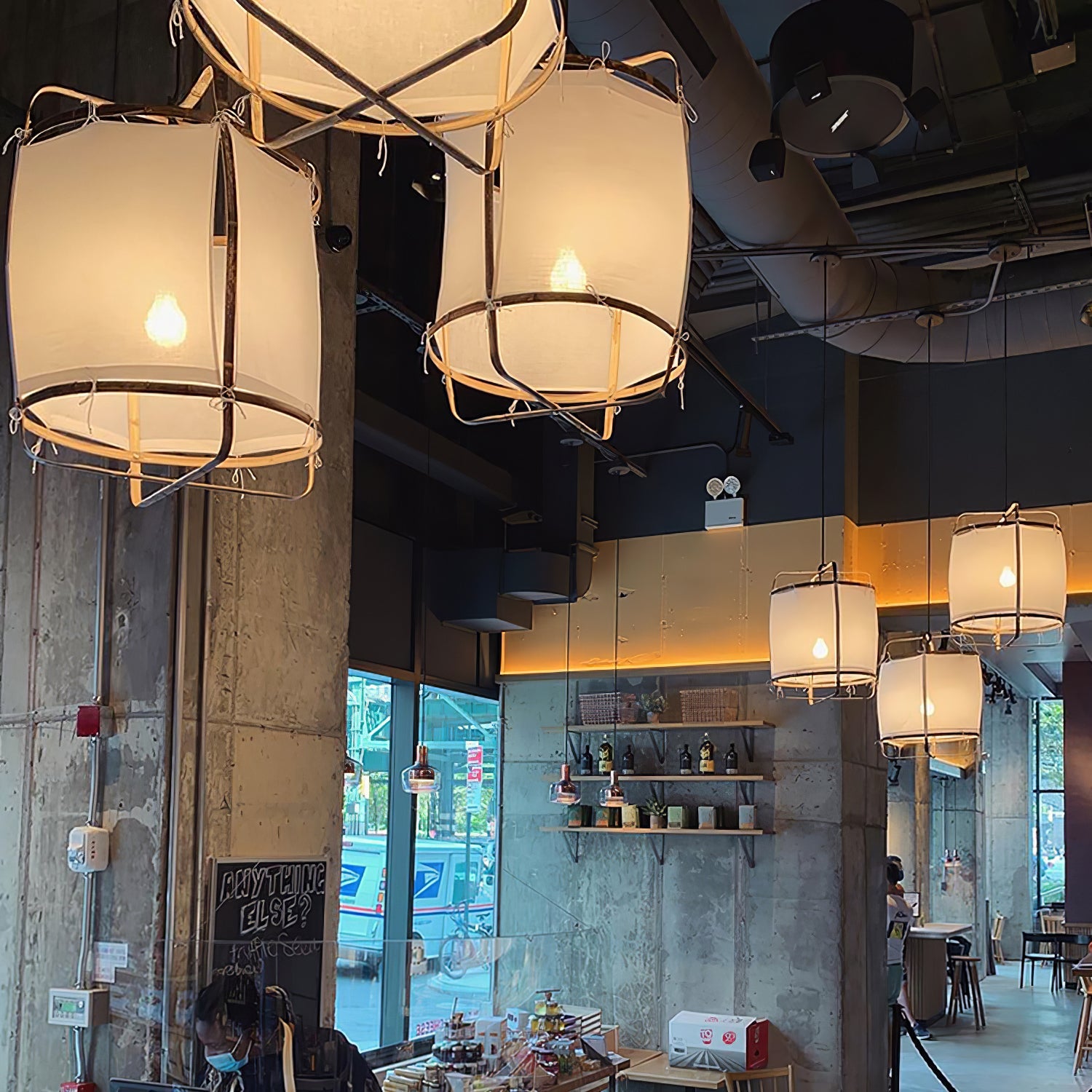 Bamboo pendant light hanging above a seating area