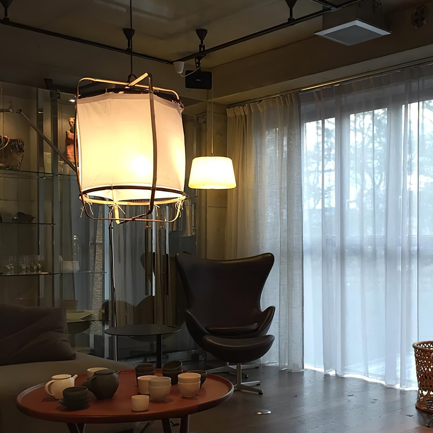 Bamboo pendant light with linen shade over a table