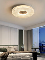 Round flush mount ceiling light with white diffuser lit