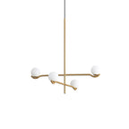 Gold Baer pendant light with white glass globes in a room