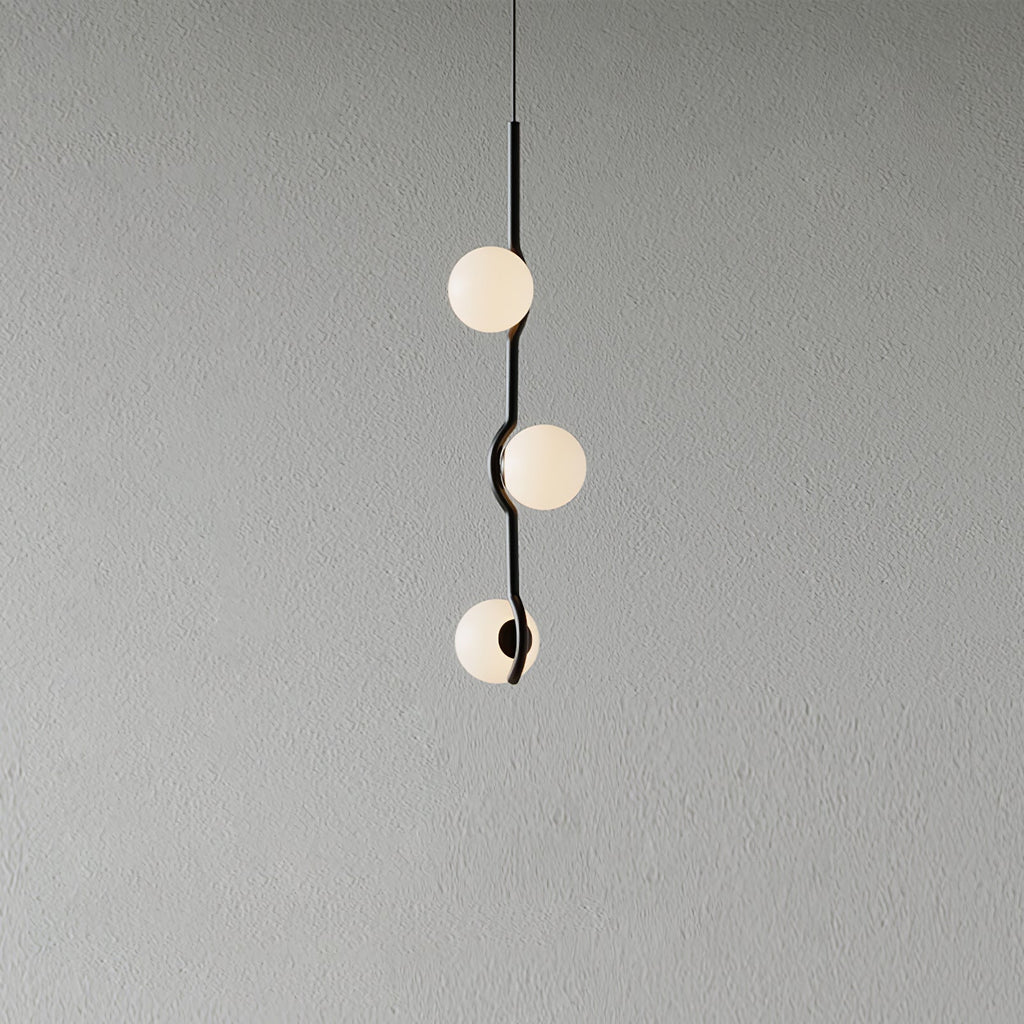 Baer pendant light with white glass shades over a dining table
