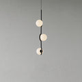 Baer pendant light with white glass shades over a dining table