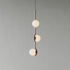 White glass Baer pendant cluster glowing softly in a living space