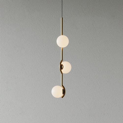 White glass Baer pendant cluster glowing softly in a living space