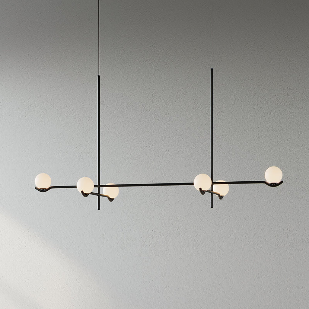 Baer pendant light cluster lit above a seating area