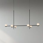 Baer pendant light cluster lit above a seating area