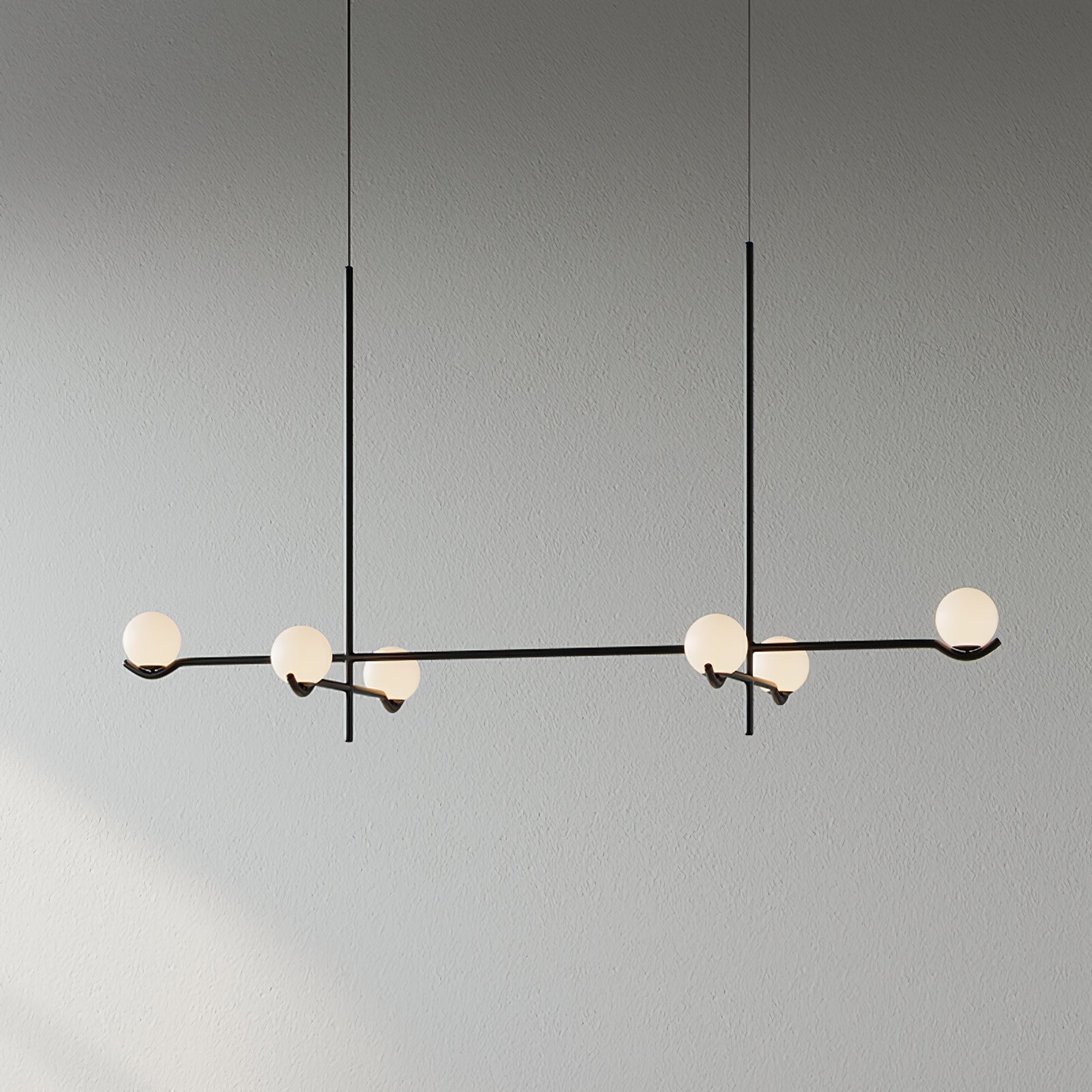 Baer pendant light cluster lit above a seating area