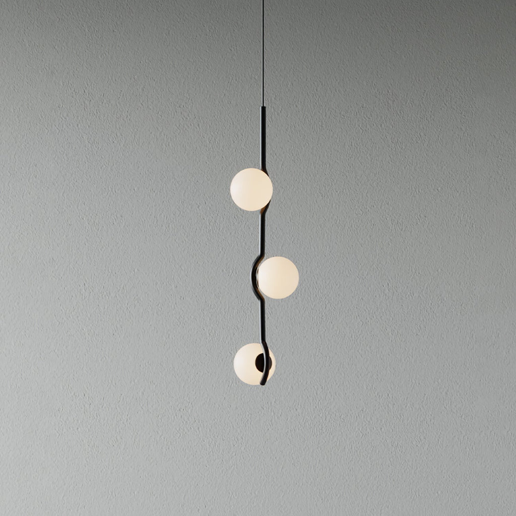 Gold Baer pendant light cluster lit above a table