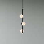 Gold Baer pendant light cluster lit above a table