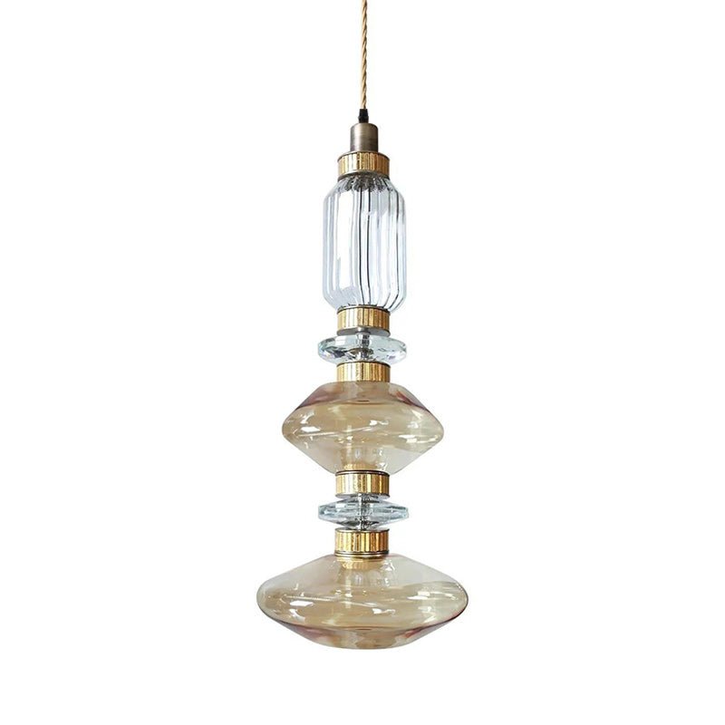 Glass pendant light with gold body in a styled interior