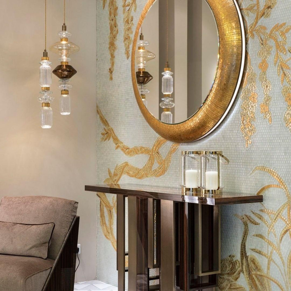 Handcrafted glass pendant light with gold body lit warm