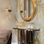 Handcrafted glass pendant light with gold body lit warm