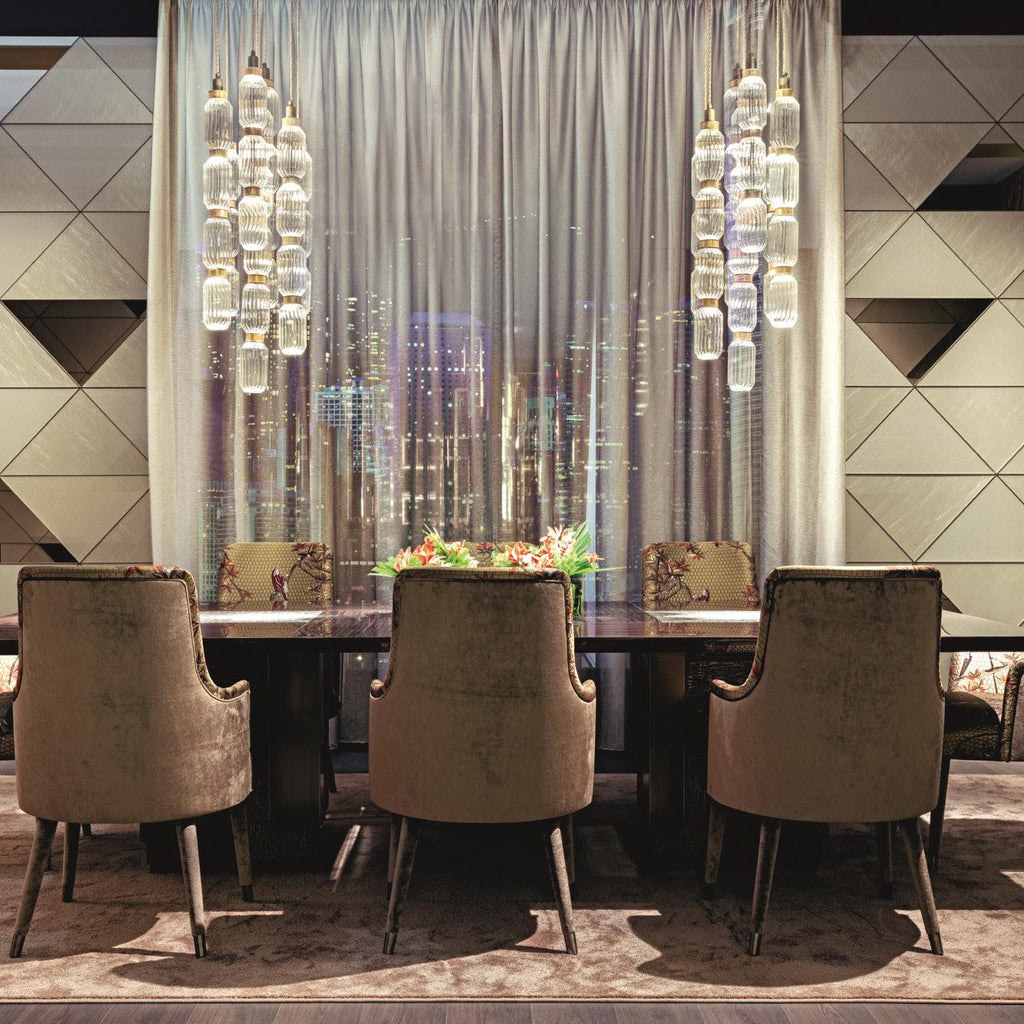 Glass pendant light hanging above a modern dining setting