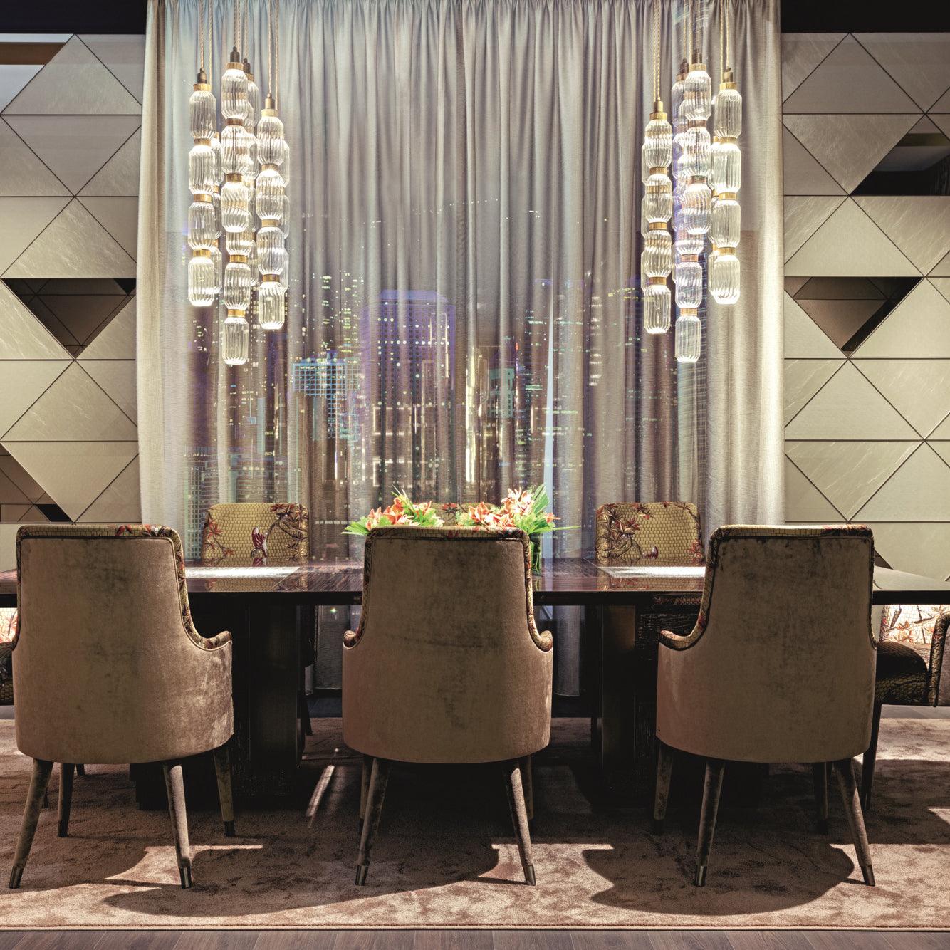 Glass pendant light hanging above a modern dining setting
