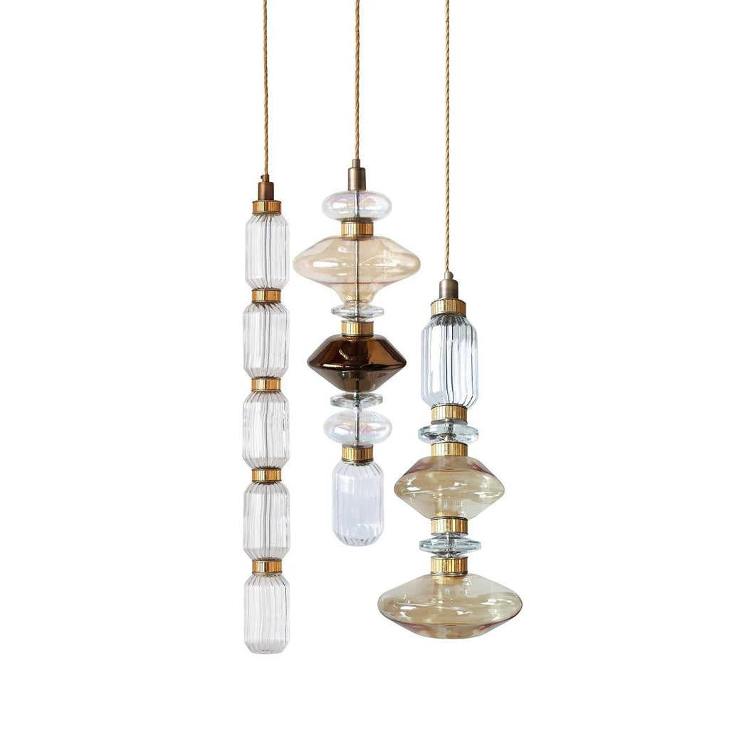 Glass globe pendant light with gold cable hanging down