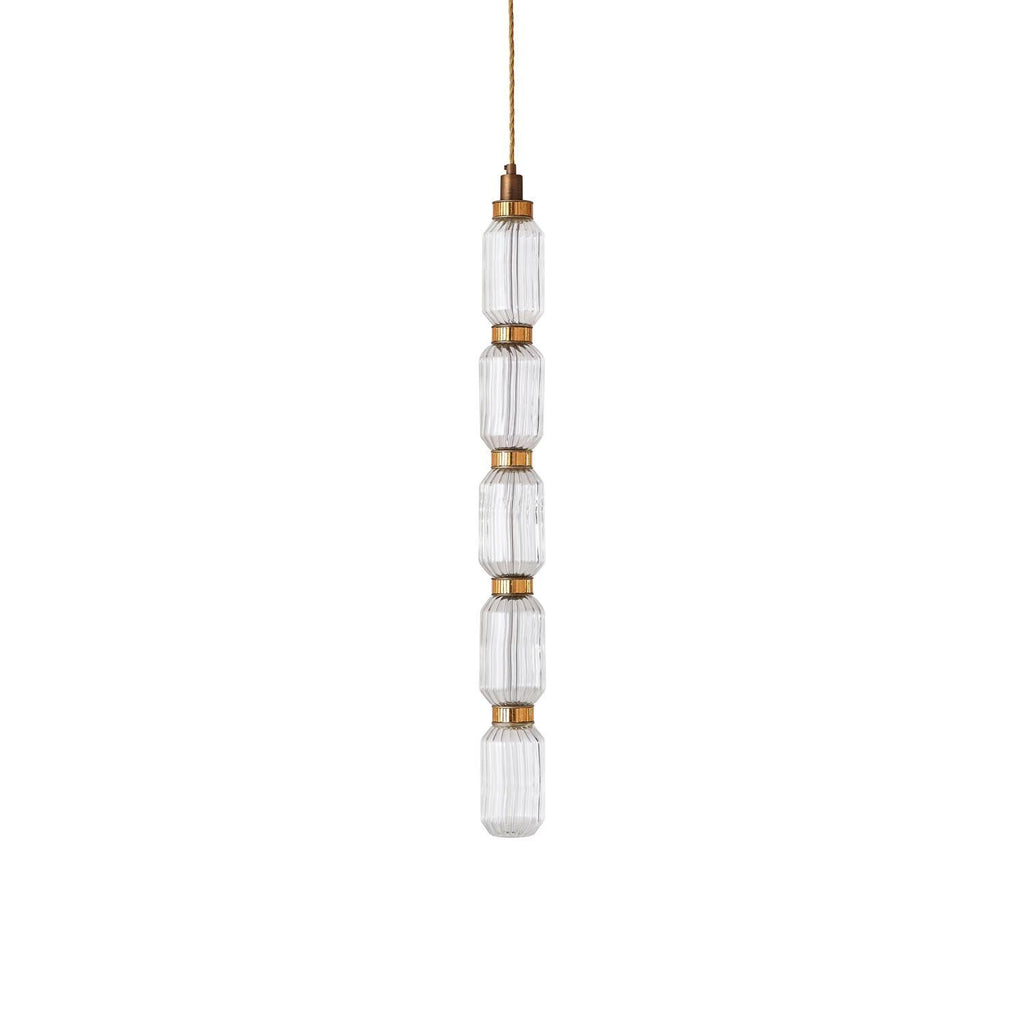 Ballet glass pendant light glowing above a table