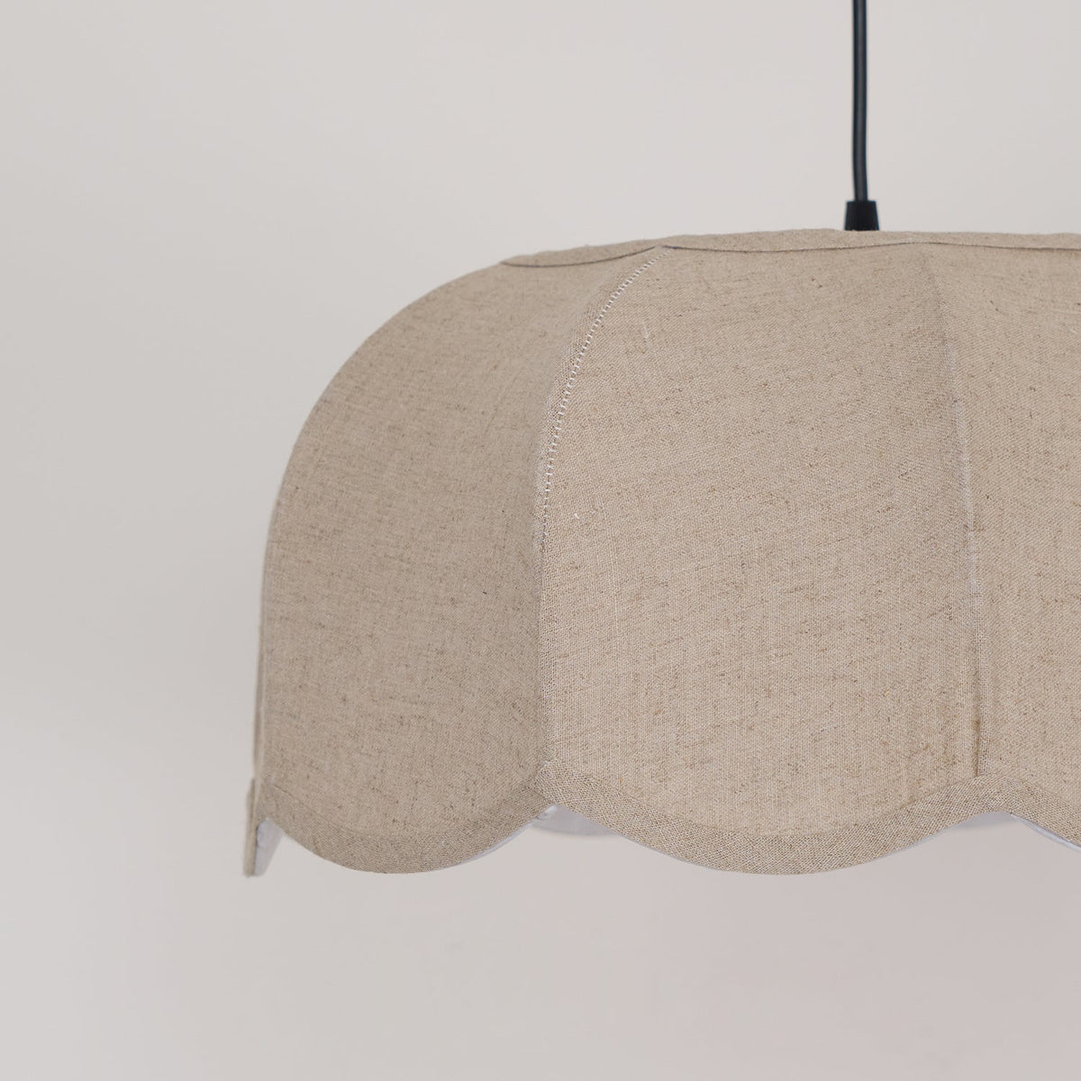 Close view of the scalloped shade exterior on this Clérachic pendant lamp, its petal seams visible.