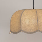 Close view of the fabric weave on this Clérachic pendant lamp's shade, lit softly from within.
