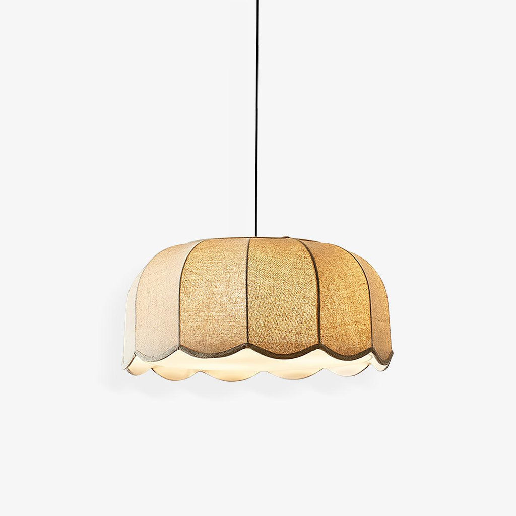 Lit on a black cord against a plain light grey backdrop, this beige Clérachic pendant lamp hangs at full length.