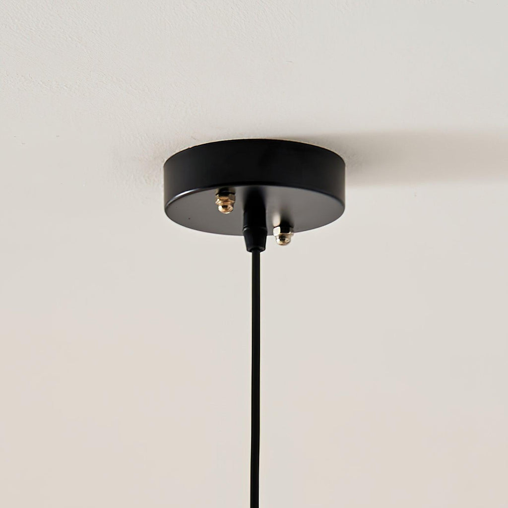 Close-up of the black ceiling canopy and cord fixing for this Clérachic pendant lamp.