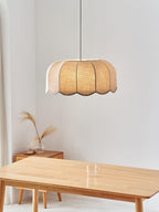 Above a wooden bench with a small vase of pampas grass nearby, this beige Clérachic pendant lamp hangs on its cord.