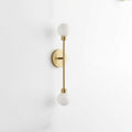Close view of this Clérachic sconce in brass finish, showing the vertical rod between its two ball shades.