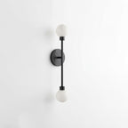 Studio shot of this Clérachic sconce in matte black finish, its alabaster ball shades on a slim rod.