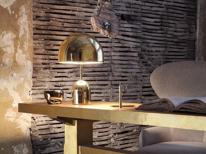 On a rustic wood and brass table against a weathered slat wall, this Clérachic chrome table lamp catches the light.