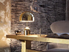 On a rustic wood and brass table against a weathered slat wall, this Clérachic chrome table lamp catches the light.