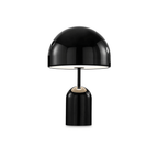This Clérachic table lamp in black shows a thin gold ring accent where the dome meets the stem.