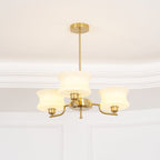 Glass globe chandelier in gold finish lighting a living room