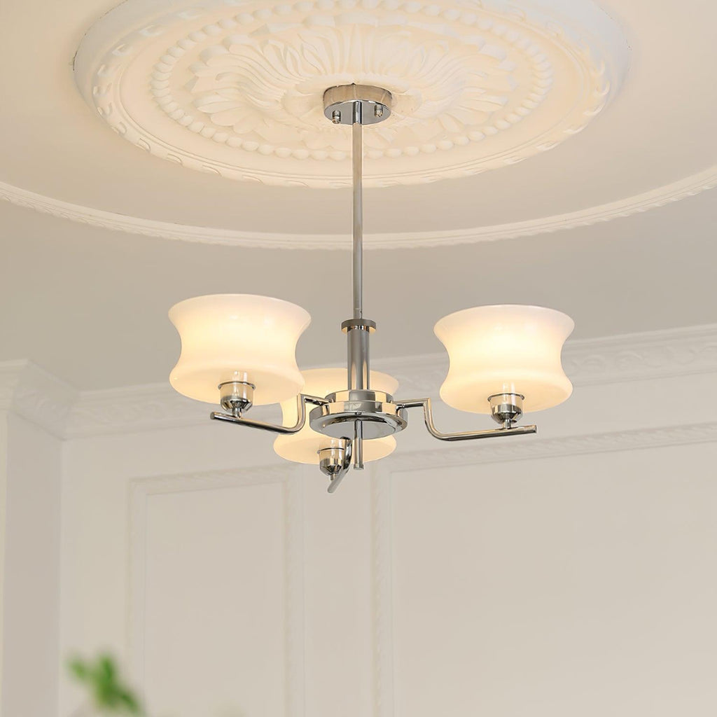 Globe chandelier with warm light through white glass shades