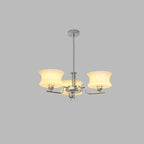Glass globe chandelier glowing over a dining table setting
