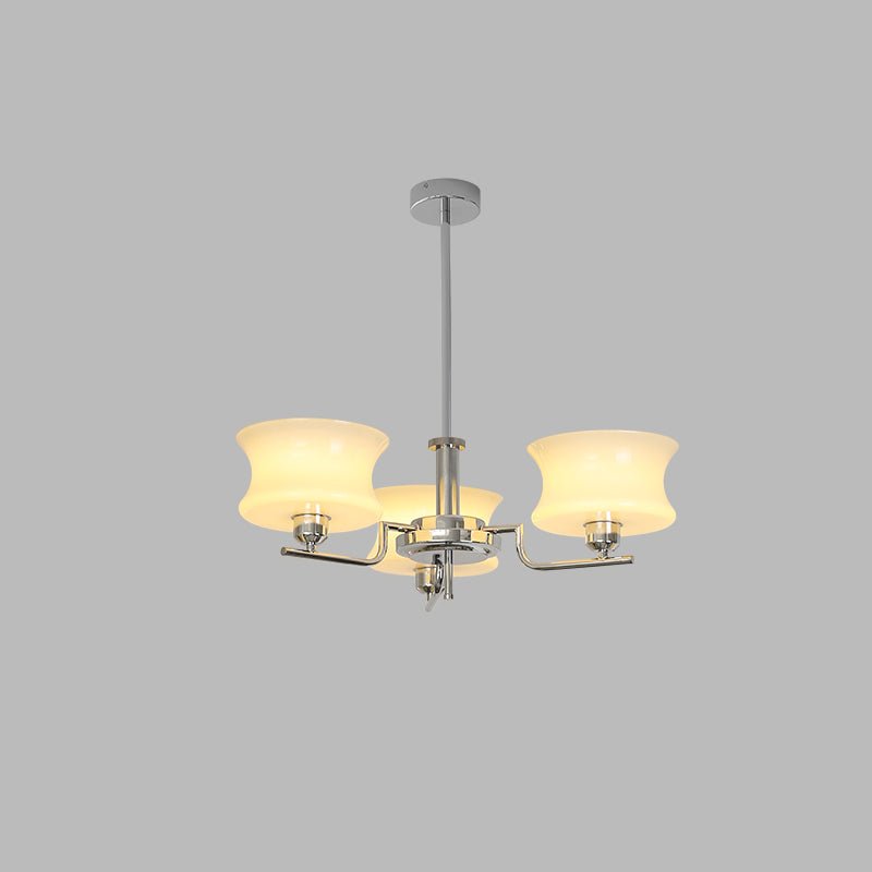 Glass globe chandelier glowing over a dining table setting