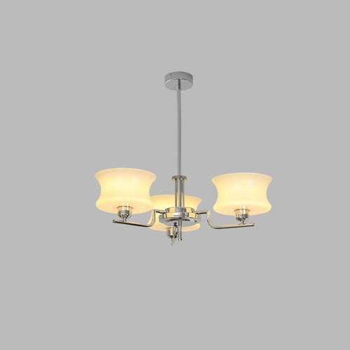 Glass globe chandelier glowing over a dining table setting