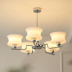 Five-head globe chandelier casting warm light over a table