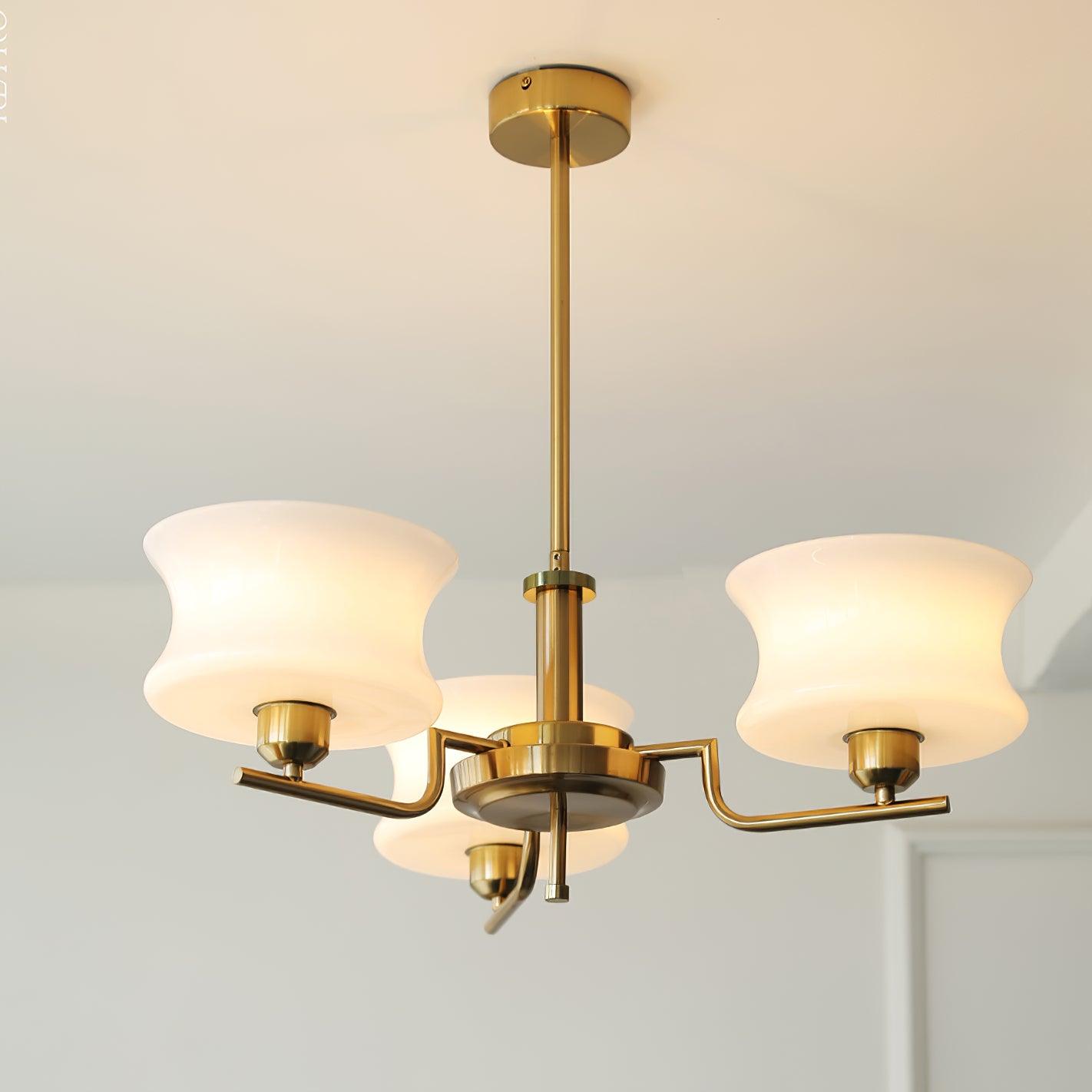 Three-head globe chandelier in chrome finish above a table