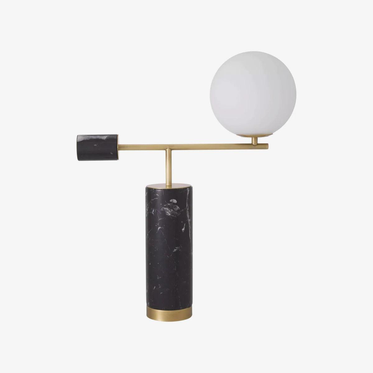 A Clérachic desk lamp with a black marble base and counterweight sits on white, its glass globe shown unlit.