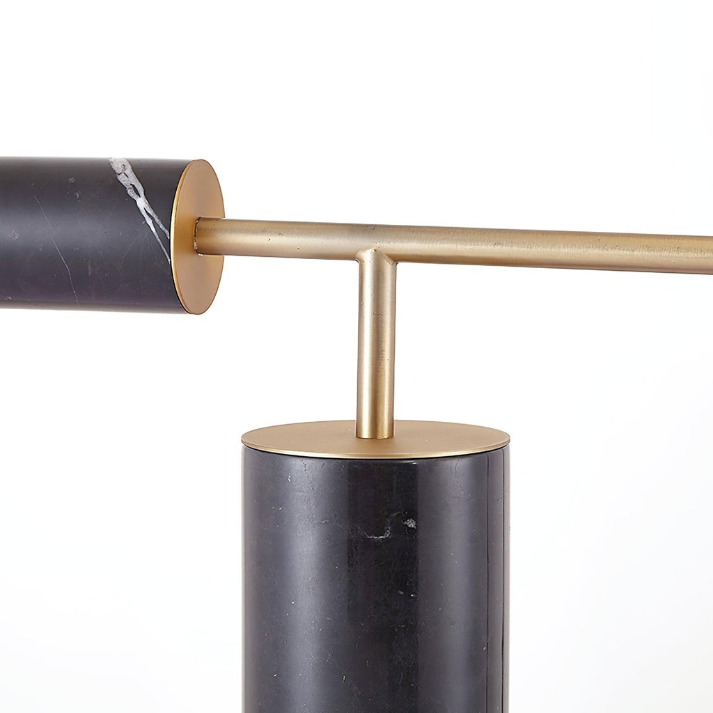 Close-up of the Clérachic desk lamp's arm joint, where the marble counterweight meets the gold rod above the base.