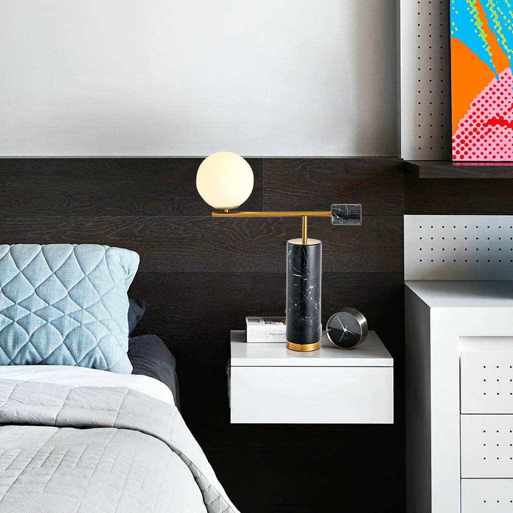 Another view of the Clérachic desk lamp on the same dark-panelled nightstand, cropped closer around the lit globe.