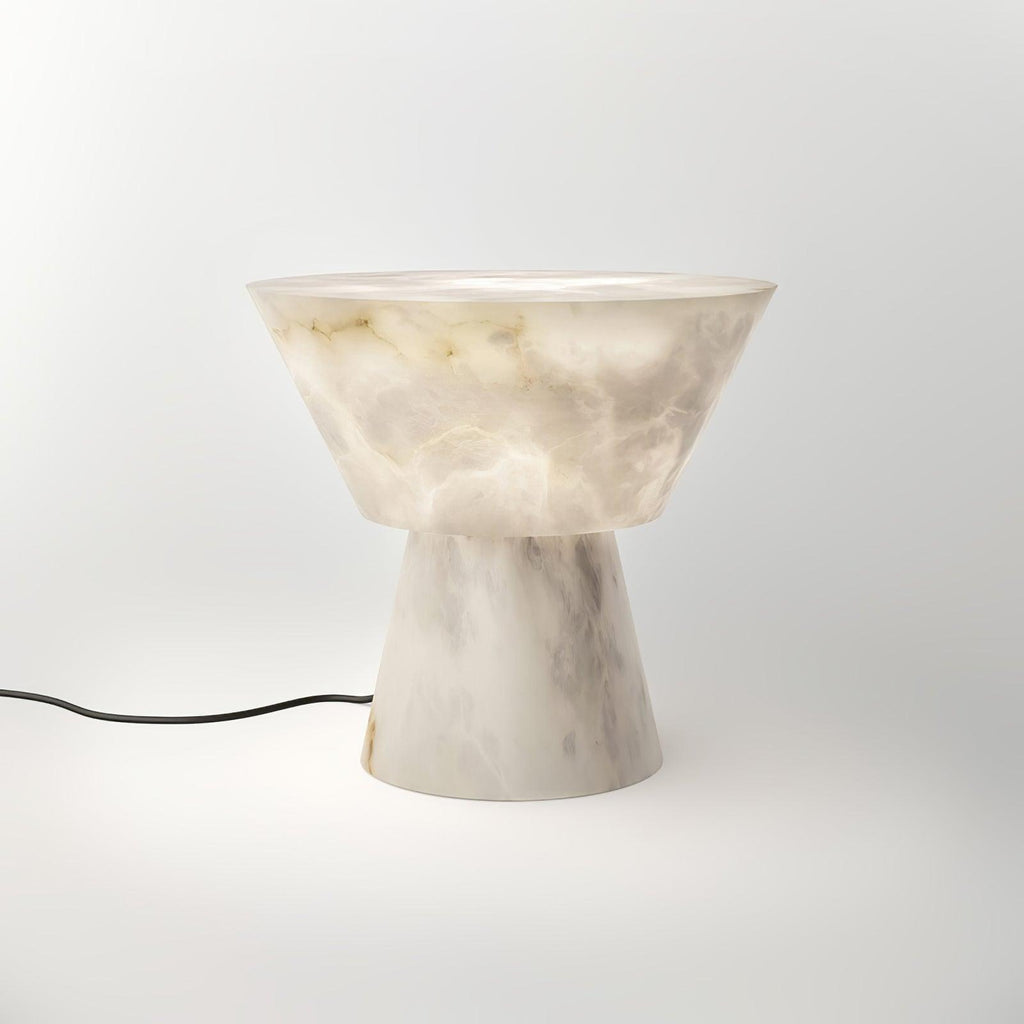A black power cord trails from the Clérachic alabaster lamp's base across the white studio background.