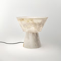 Lit noticeably brighter here, the Clérachic alabaster lamp sits on white with no cord in view.